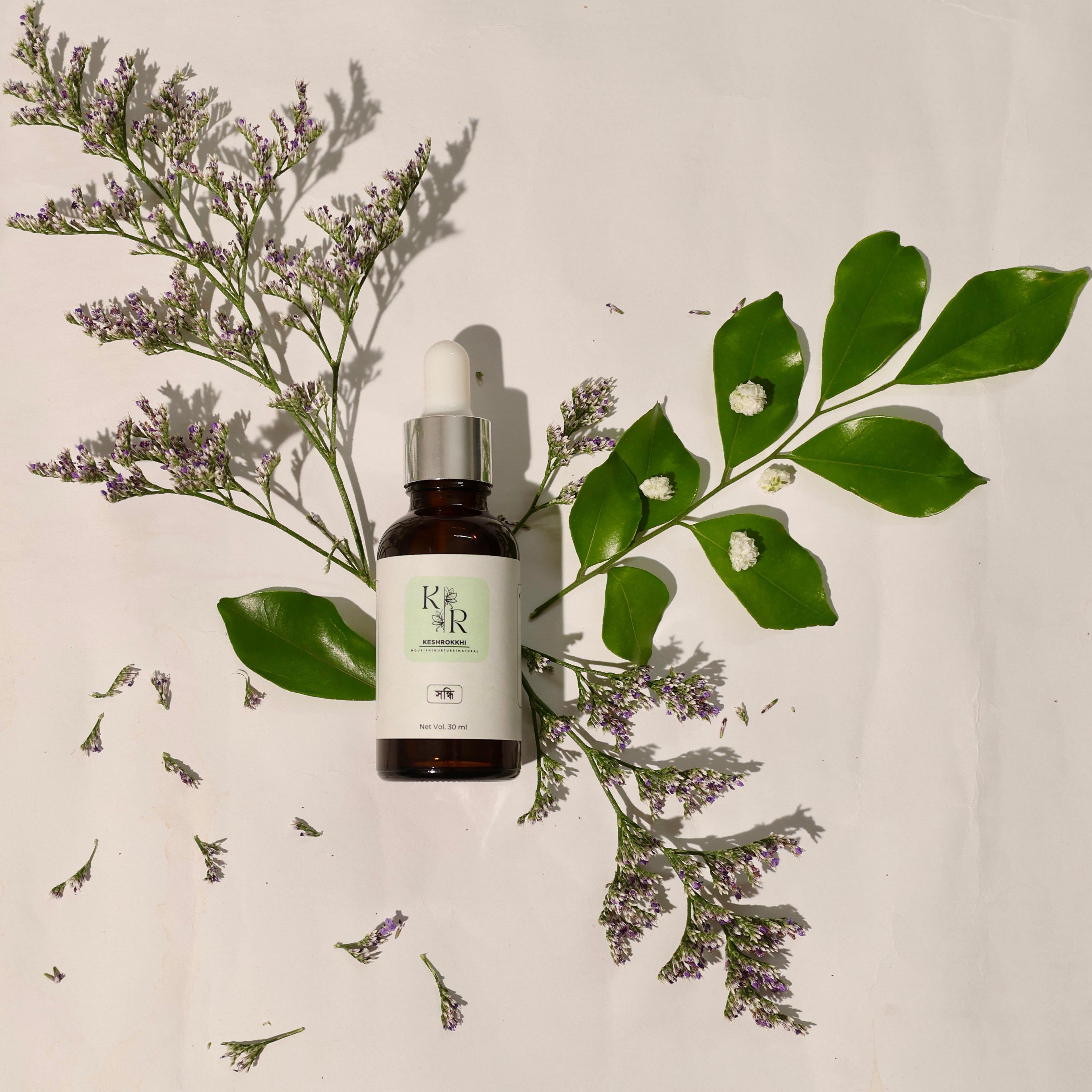 Shondhi Serum by Keshrokkhi placed with some ingredients, lavender oil| Olive oil| natural ingredients